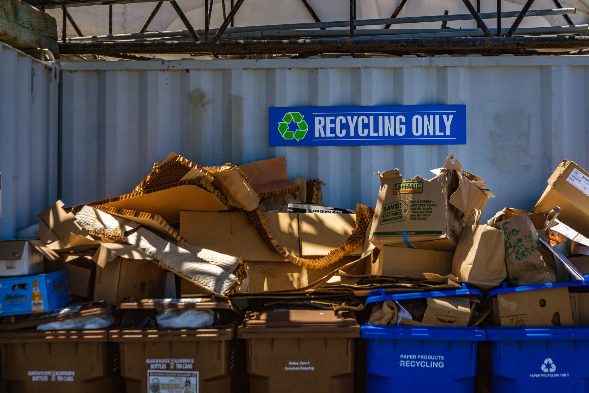 Recycling area filled with cardboard and paper materials, promoting sustainability. (Photo by Robert So on Pexels)