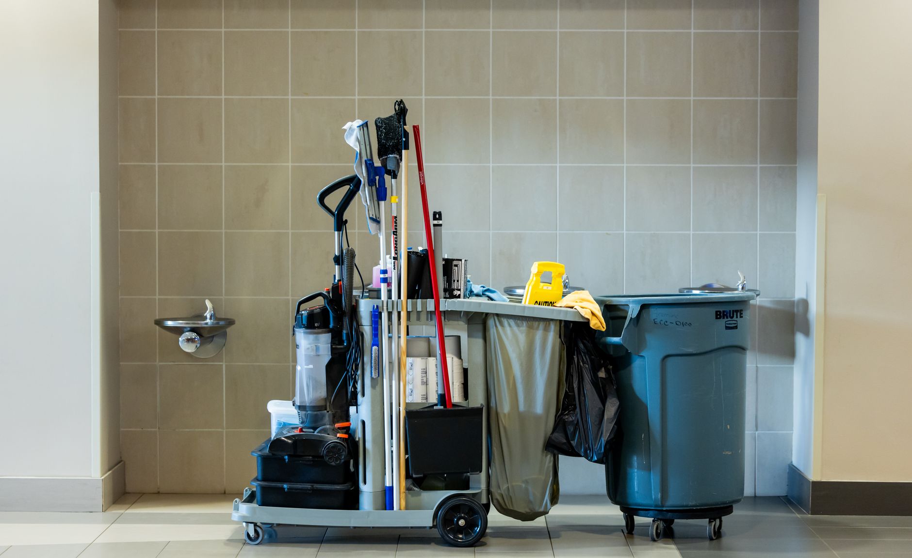 A comprehensive collection of professional cleaning tools on a cart in an indoor environment. (Photo by Caleb Oquendo on Pexels)